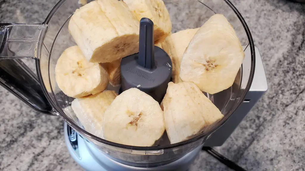 Prepare the alcapurrias masa by pulsing the green bananas and plantains in the food processor.