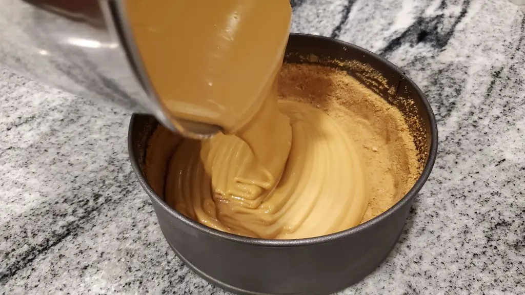 Pouring filling into the cheesecake crust