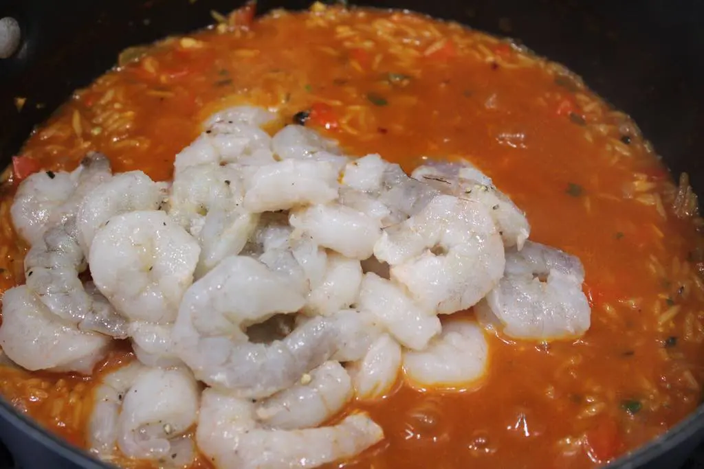 Adding shrimp to Puerto Rican Shrimp Stew