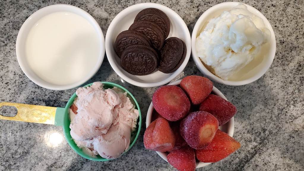 Oreo cookies, frozen strawberries, milk and ice cream