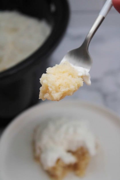 Biting into a piece of slow cooker coconut cream cake.