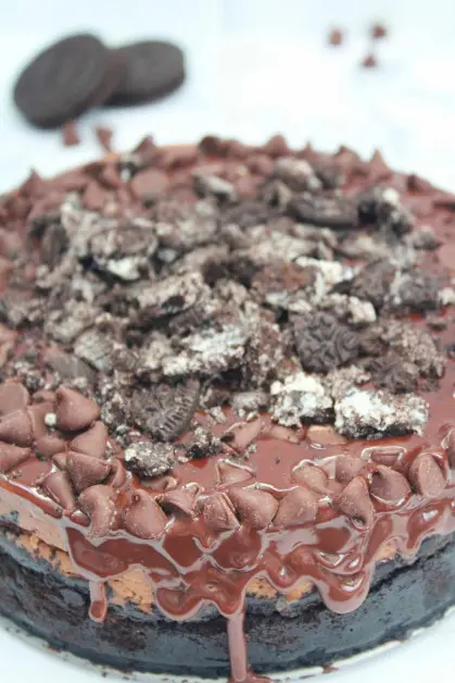 Chocolate cheesecake is made with chocolate ganache, cream cheese, sugar, sour cream, cocoa powder, vanilla extract, oreo cookies, melted chocolate and a few other ingredients.