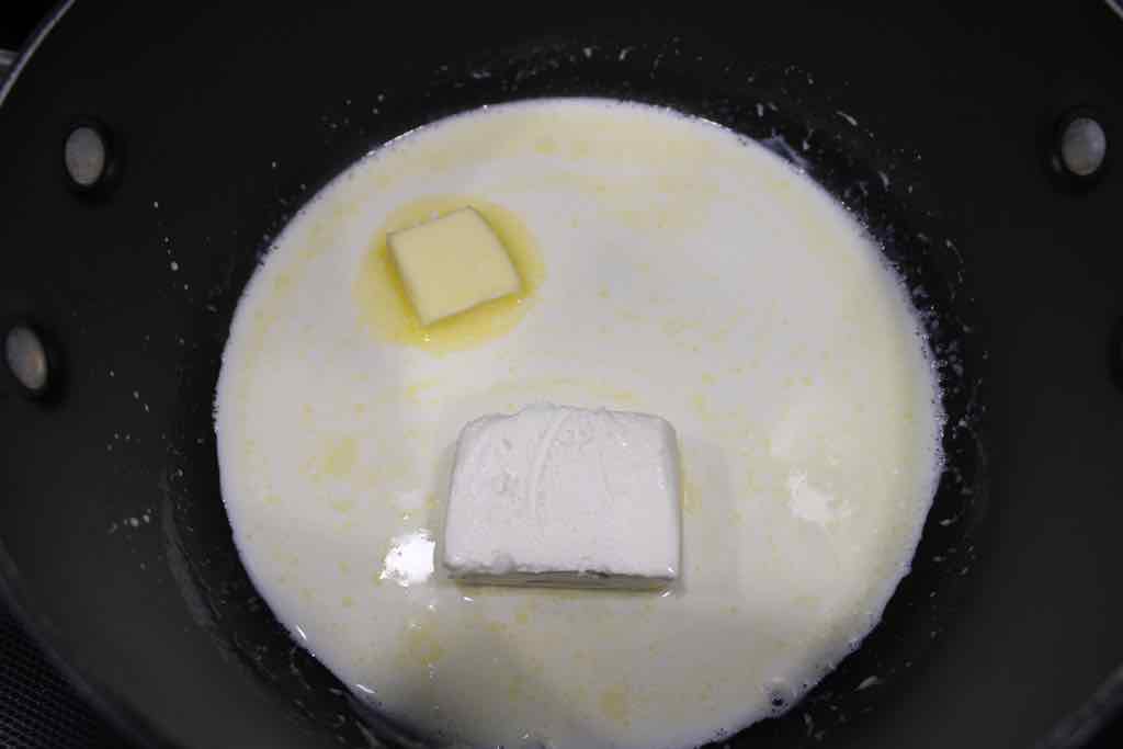 Melt cream cheese and butter in a sauce pan with heavy cream to make the cheese sauce.