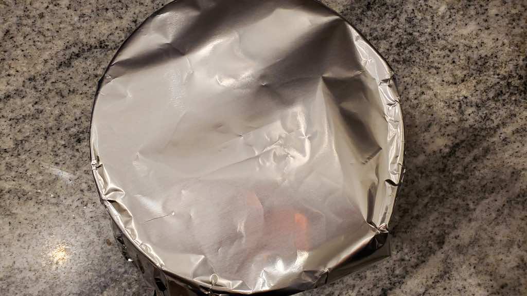 Use aluminum foil to cover the cheesecake before cooking.