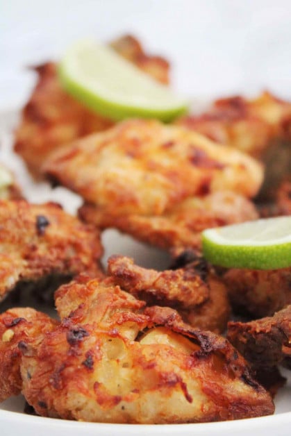 Extra crispy chicharron de pollo being served with fresh lime juice.