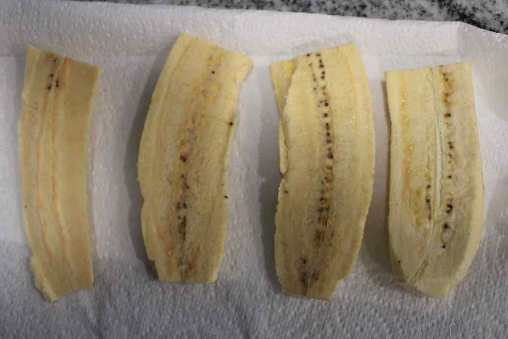 Cut each plantain in half then cut each half down the middle lengthwise. 