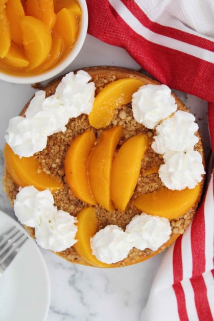 Instant pot peach cobbler cheesecake being served.