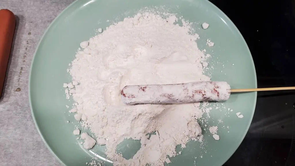 This is how you coat the hot dogs in flour.