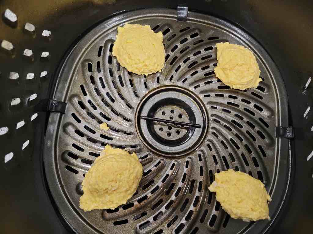 Scoop the batter and place each dollop inside the air fryer.