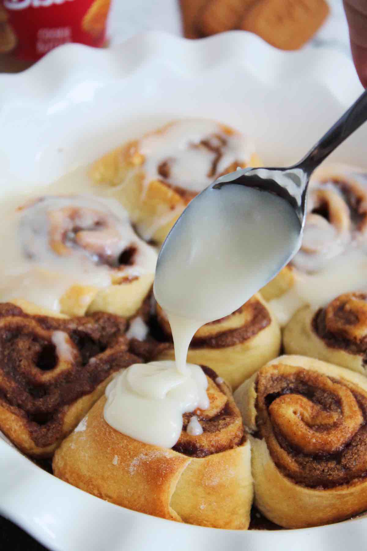 Pour the cream cheese icing over the cinnamon rolls while they are still warm.