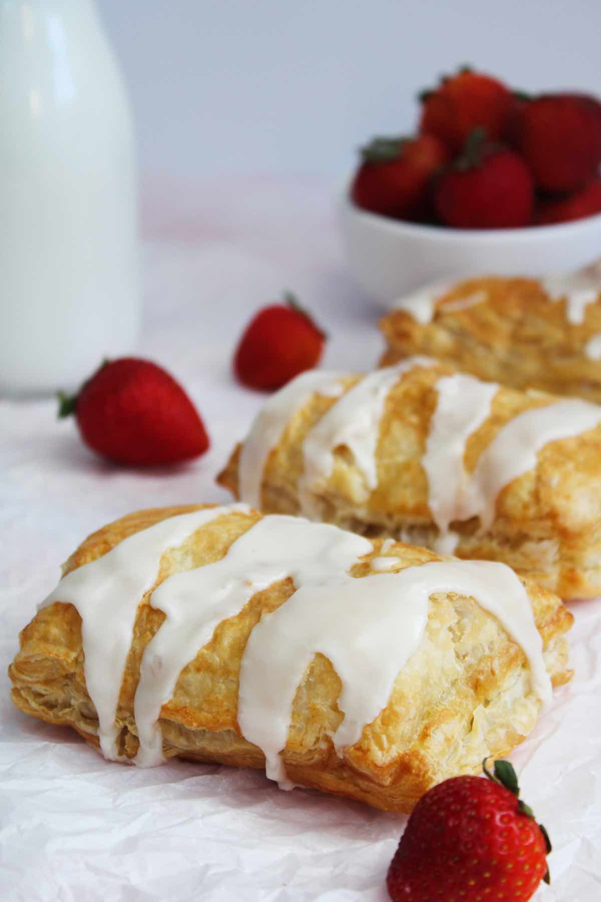 Homemade air fryer toaster strudel recipe with strawberry filling and vanilla icing.
