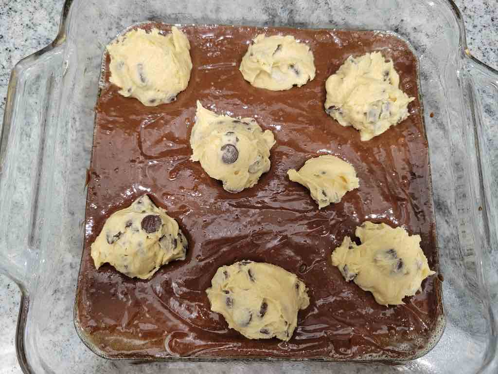 Drop about 2 tbsp of cookie dough into the fudge brownie batter just like this.