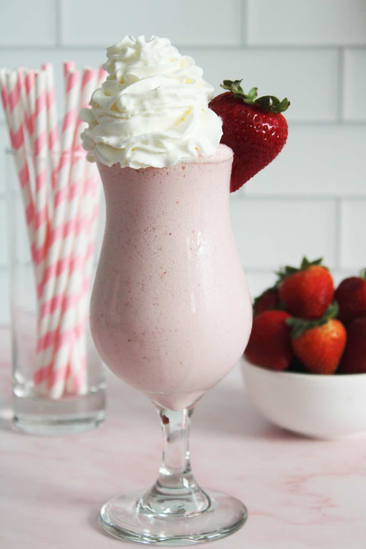 Homemade strawberry milkshake with strawberry ice cream.