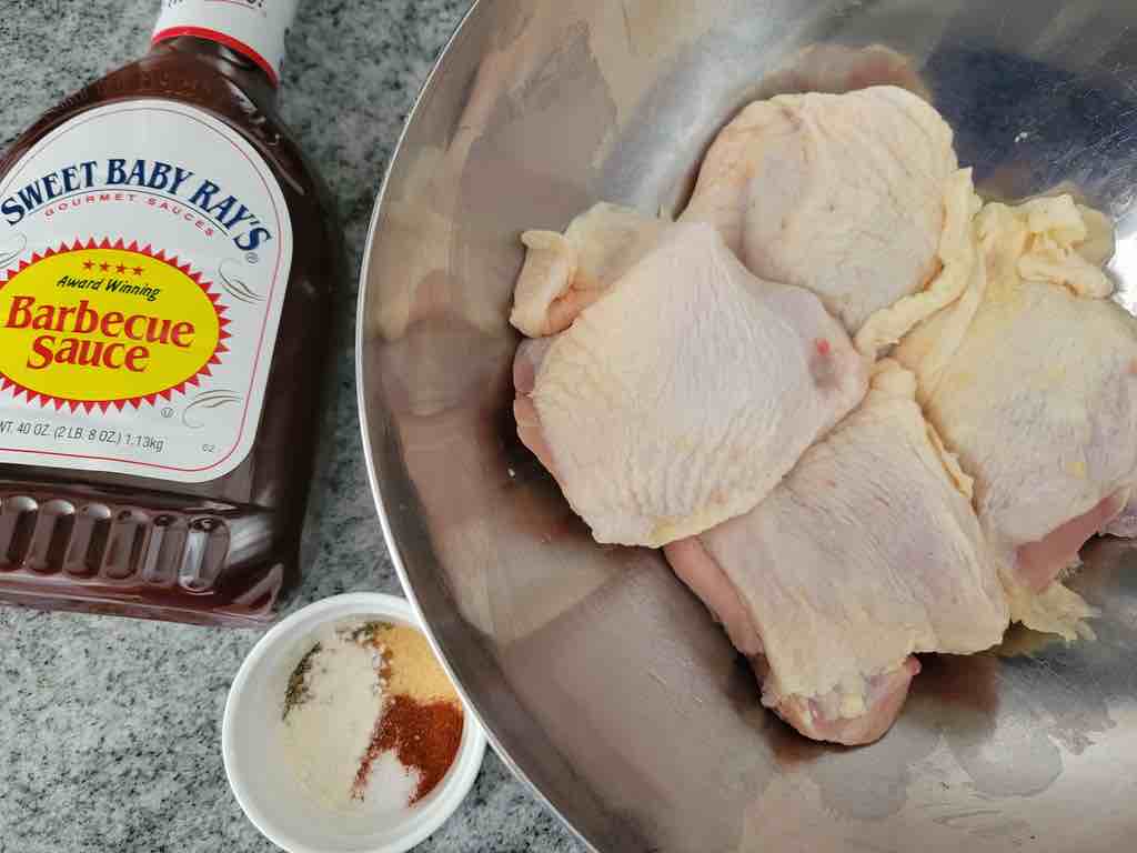 The ingredients needed are chicken thighs, barbecue sauce, and a seasoning blend of your liking.