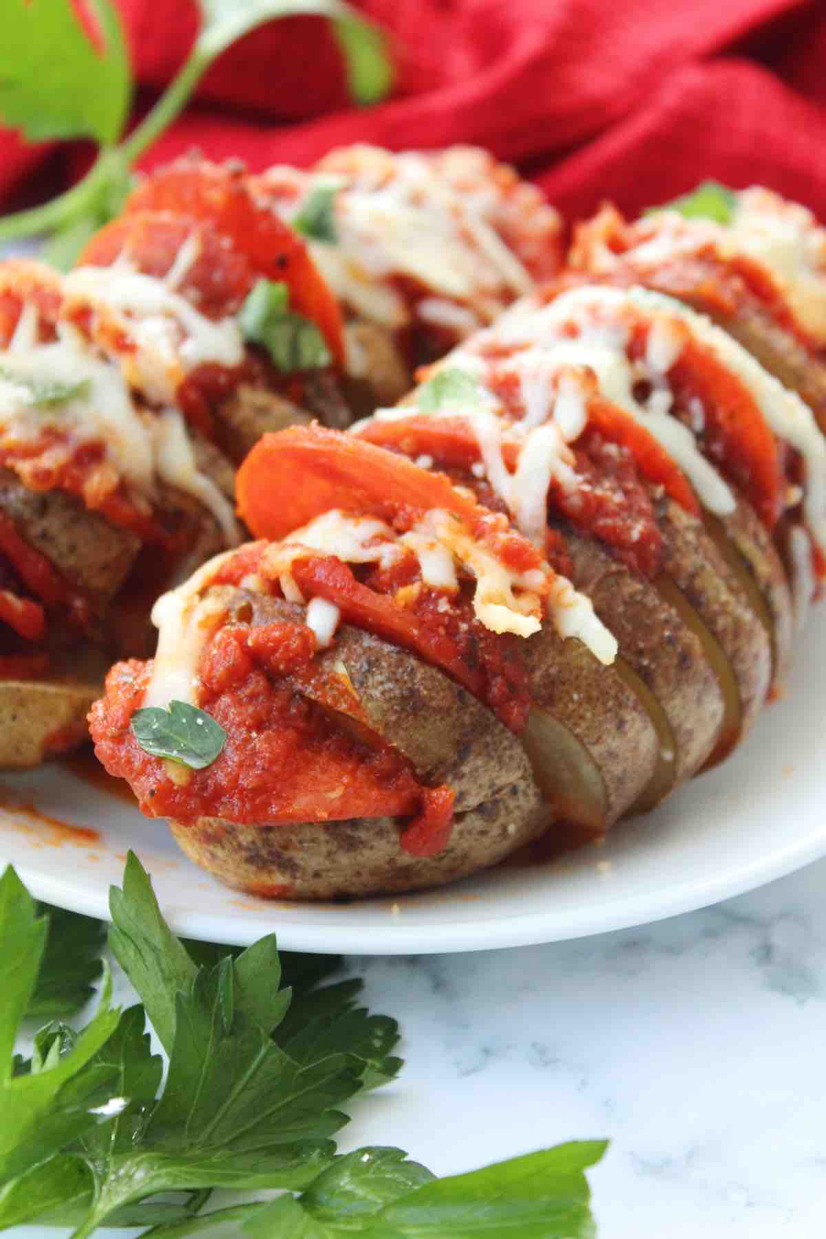 This recipe for oven baked pizza hasselback potatoes is easy and perfect for a weeknight meal.