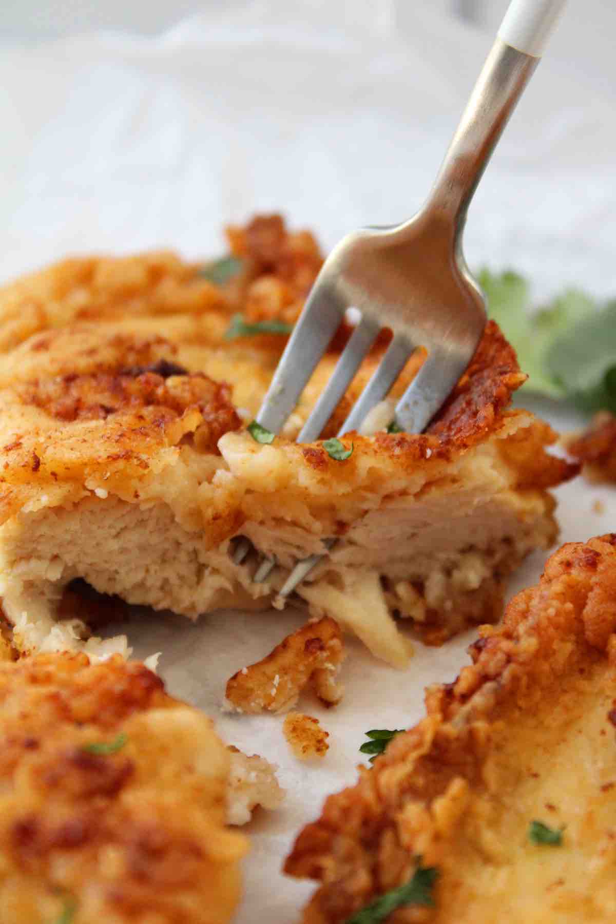 Deep fried chicken breast is cooked until golden and crispy.