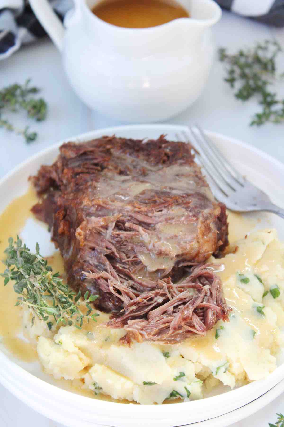 Chuck roast beef made in the pressure cooker is served with homemade gravy in this photo.