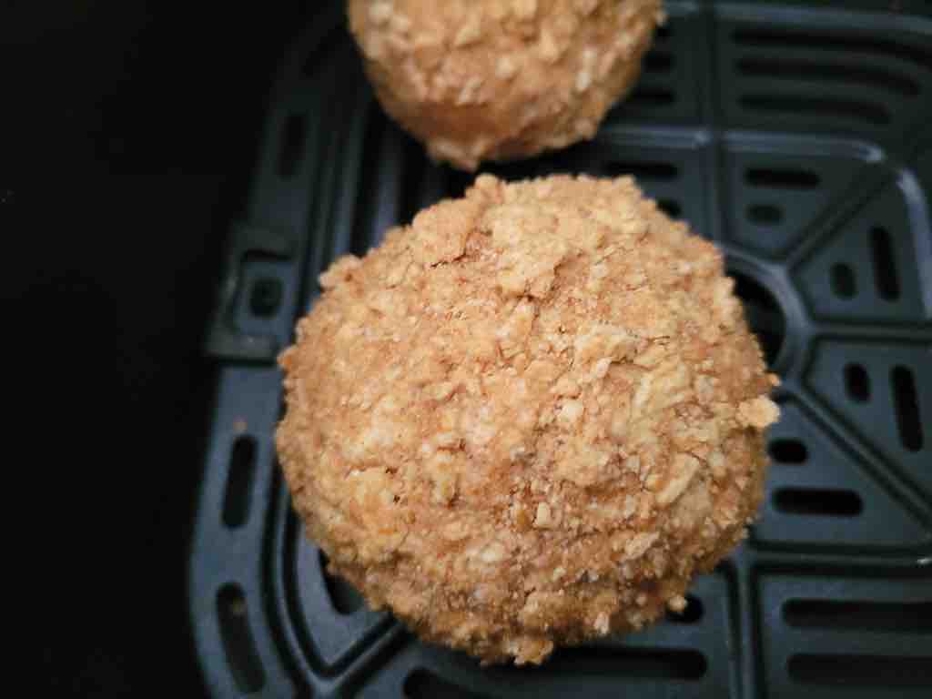Roll the ice cream into balls and roll into the crushed cereal. Chill for 3-4 hours in the freezer then transfer to the air fryer as seen in this photo.