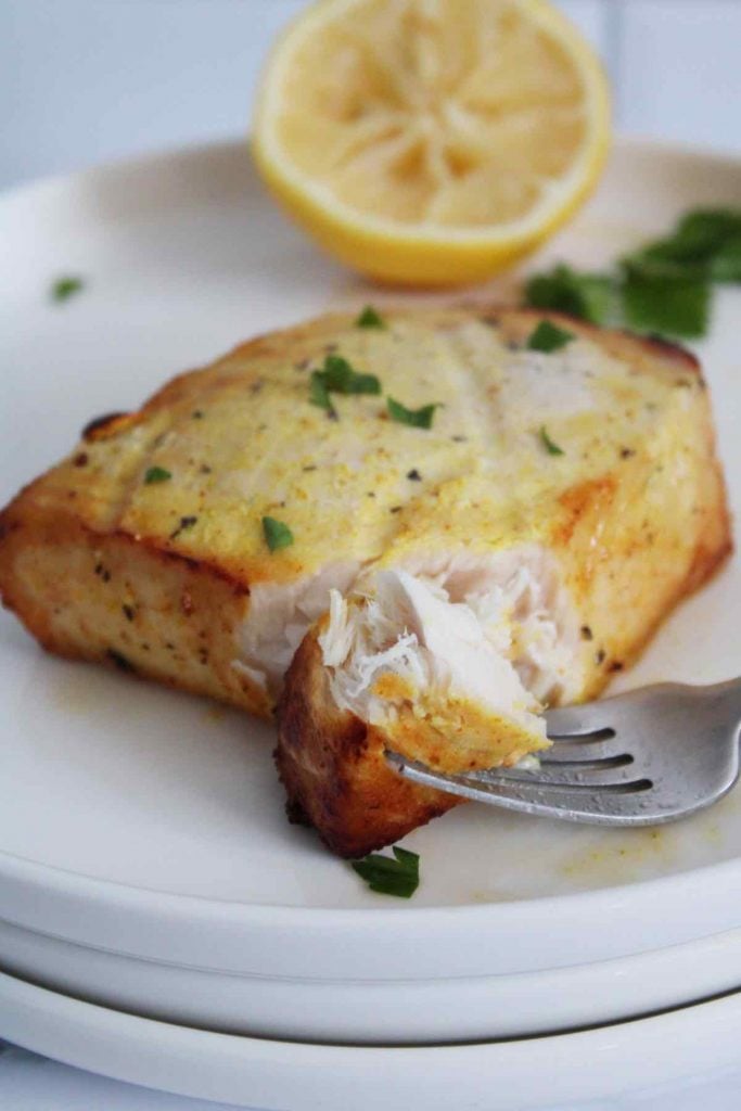 Swordfish steaks are seasoned with spicy adobo seasoning before being cooked in the air fryer.