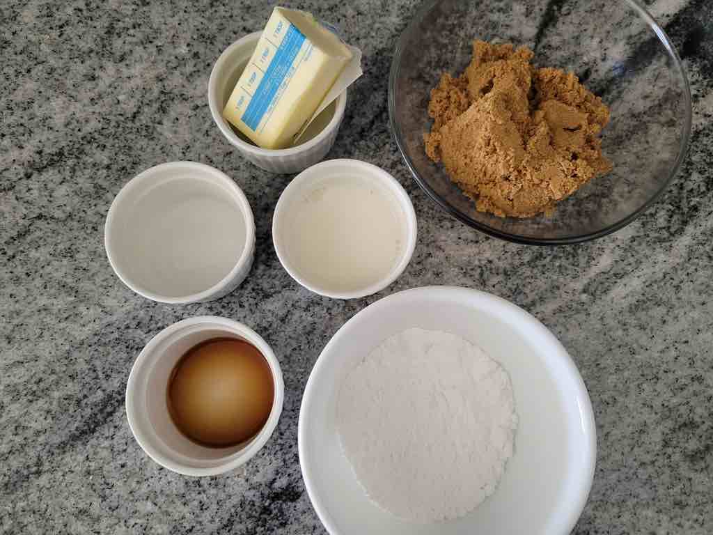 The ingredients needed for this recipe are brown sugar, powdered sugar, butter, milk, almond extract and vanilla extract.