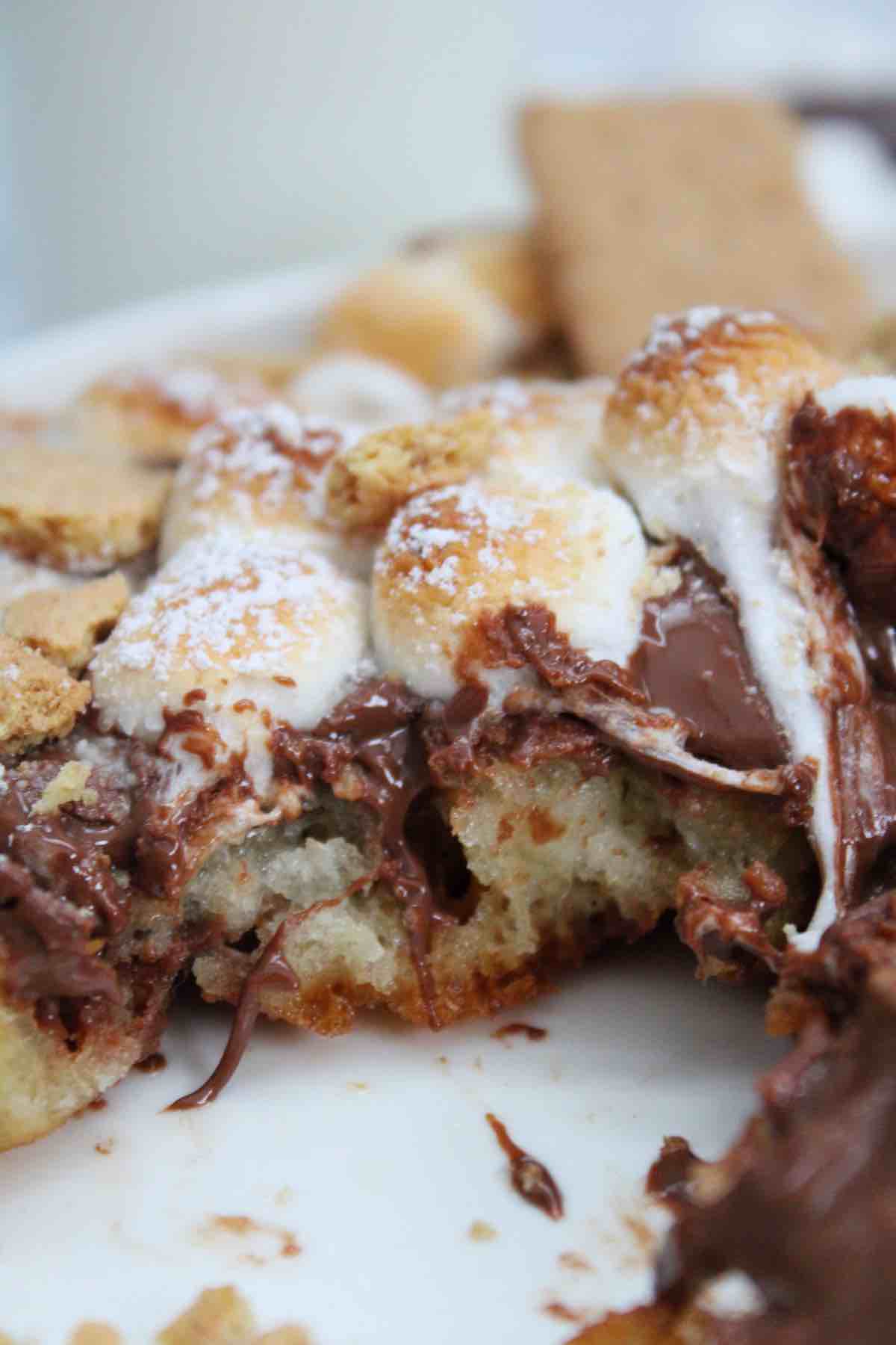 Serve s'mores funnel cakes with powdered sugar and crushed graham crackers.