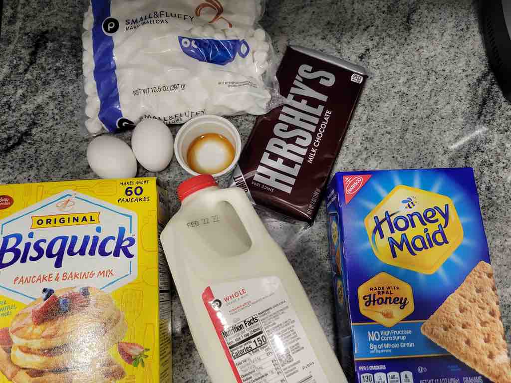 The ingredients needed for this recipe are bisquick baking mix, milk, eggs, vanilla extract, chocolate, marshmallows, graham crackers and powdered sugar.
